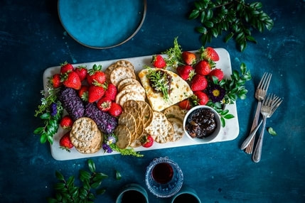 Picture of plate with cheese, crackers, and strawberries.and 